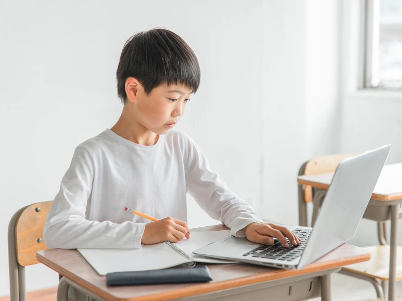 Middle school student studying with a laptop